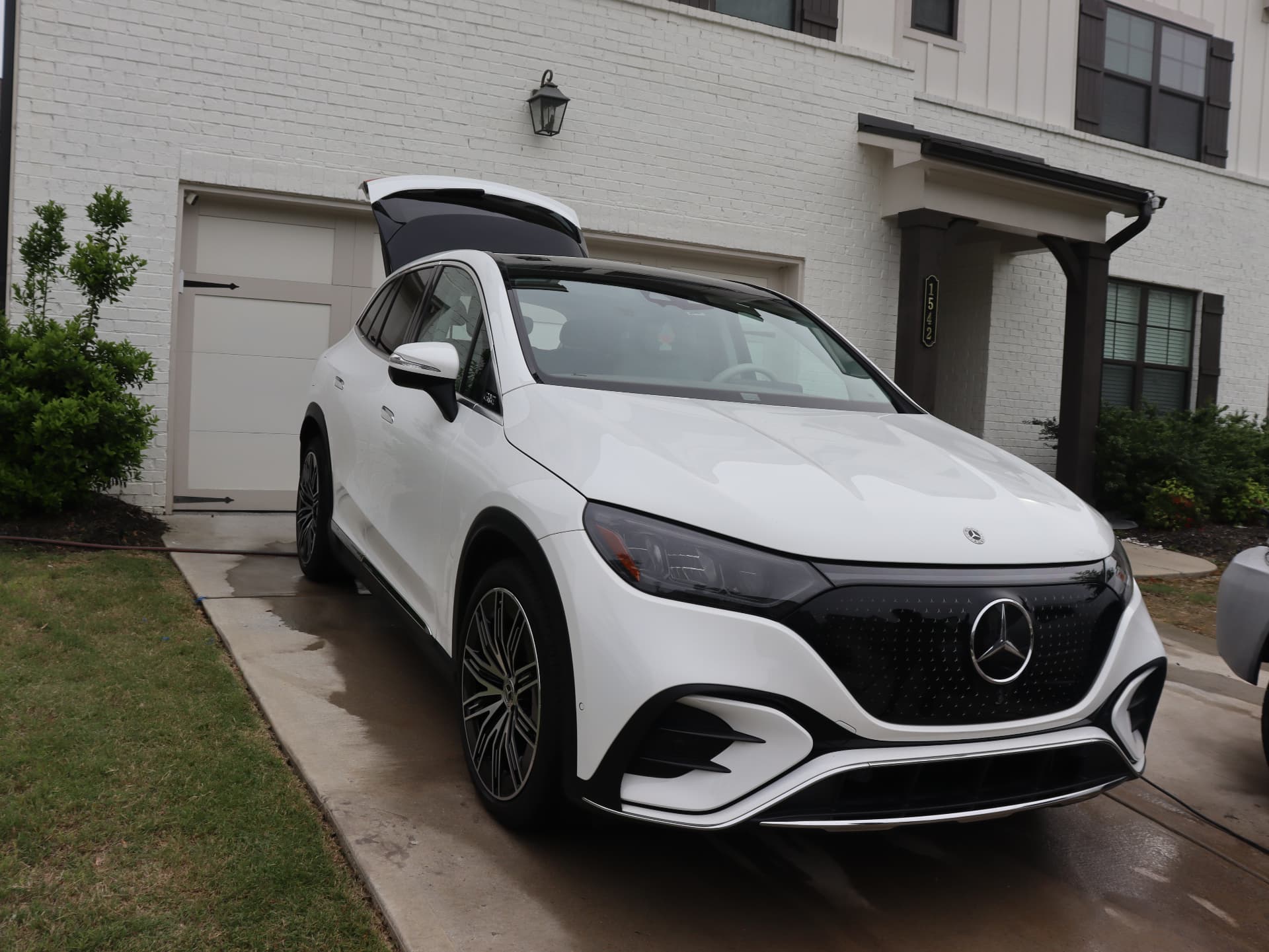 Freshly detailed white Mercedes-Benz EQS SUV in a driveway